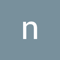 Lowercase white letter 'n' on a blue-gray square background.